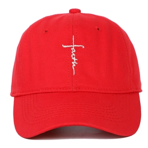 Close-up of white faith cross embroidery on red cotton baseball cap front