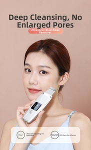 Close-up of portable ultrasonic skin scrubber used on face for pore cleaning and EMS care