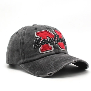 Close-up of distressed brim and red New York embroidery on vintage charcoal baseball cap