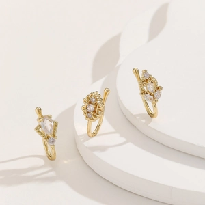 Three-piece set of gold nose rings with sparkling zircons in heart and floral shapes