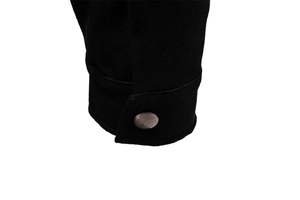 Close-up of black faux suede jacket cuff with silver metal button engraved with CLASSIC