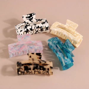 Five assorted 8.2cm acetate rectangular hair claws with marble and tortoiseshell patterns