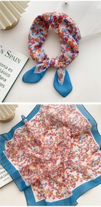 Detail of floral linen silk scarf showing vibrant blue border and small flower patterns