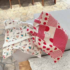 Detail of canvas tote bags featuring red polka dots and colorful cartoon dog patterns