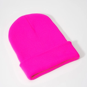 Detail view of neon pink acrylic beanie showing elastic knitted texture and ribbed cuff