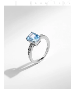 Macro detail of S925 sterling silver stamp and ice cut blue gemstone on silver ring