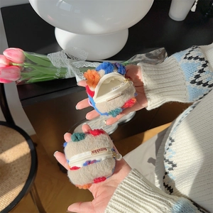 Close-up of plush bucket coin purses with colorful patchwork and pearl zipper charms