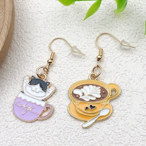 Detail of asymmetric enamel cat and coffee cup charms for earrings and DIY jewelry