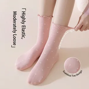 Pink polka dot crew socks with ruffled cuffs and high elastic seamless toe design