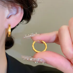 Textured gold circle hoop earrings with unique wavy brushed finish for women
