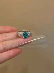 Detailed macro view of the rectangular blue gemstone ring with diamond-set lattice band