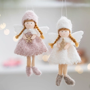 Detail of pink and white handmade felt angel dolls with glitter accents and knit textures