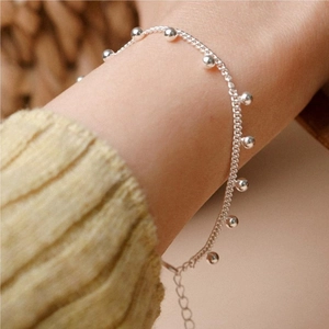 Close-up of minimalist S925 sterling silver beaded bracelet worn on a female wrist