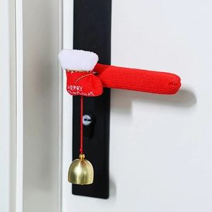 Close-up of red knitted Christmas door handle cover with a gold bell and festive embroidery