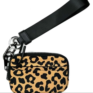Detail of leopard print coin purse with black woven wrist strap and metal carabiner