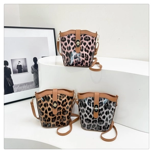 Detailed comparison of pink, brown, and gray leopard print bucket bags on display
