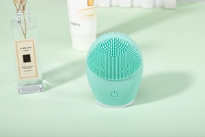 Close-up of soft silicone bristles on a mint green facial cleansing device for pores
