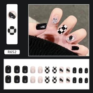 Black and white checkerboard press-on nails set with silver glitter and heart graffiti