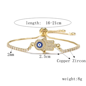 Macro view of gold Hamsa hand bracelet with zircon eye and 16-21cm size markings