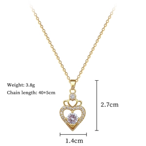 Macro detail of gold crown heart pendant necklace with shimmering crystals and dimensions