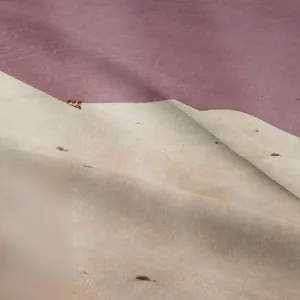 Macro shot of high-quality bohemian tapestry fabric with purple and beige textures