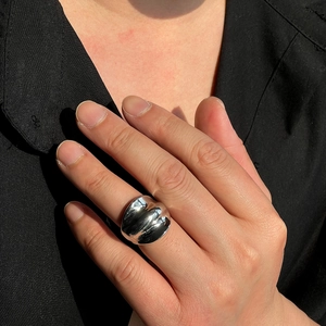 Polished silver dome ring for men with irregular vintage design in bright natural light