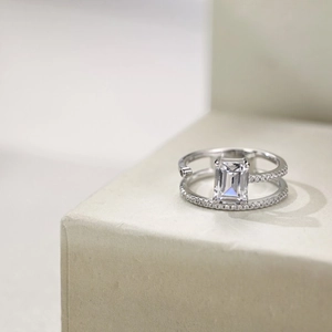 Macro detail of silver S925 ring with emerald cut crystal and double pavé diamond bands