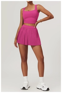 Detailed view of rose pink square neck fitness vest and matching pleated sports skirt set