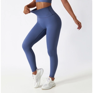 Detail showing the high-waisted elastic control and stretch of blue fitness yoga pants