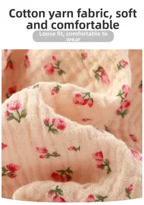 Close-up of breathable double-layer muslin cotton fabric with pink floral pattern
