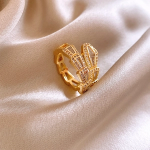 Detailed close-up of a wrap-around golden snake ring with sparkling zircon inlay