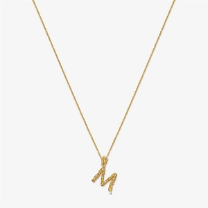 Detailed macro view of S925 silver letter M pendant with vintage hammered gold texture