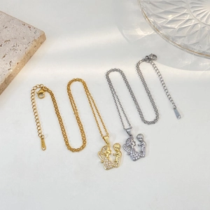 Elegant mother and child hug pendant necklace in gold and silver finish with white crystals