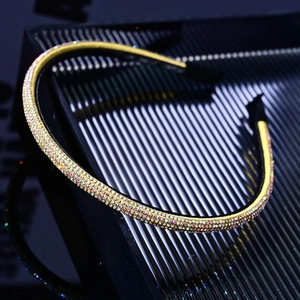 Close-up of sparkling colorful rhinestones on a thin gold metal headband for women