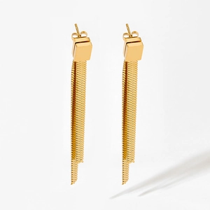Detailed view of gold square stud earrings with long double snake bone chain tassels