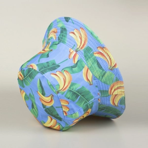 Close-up of blue sun hat with vibrant yellow banana and green leaf patterns