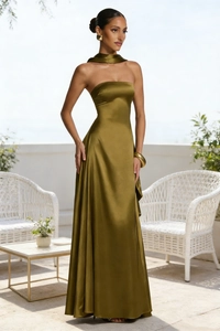 Close-up of olive green satin dress fabric showing luxurious texture and backless detail