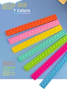 Detail view of colorful pop-it fidget rulers with a 12cm scale in various candy colors