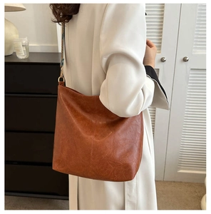 Detail of caramel brown retro tote bag with ethnic jacquard wide shoulder strap for women