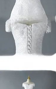 Detail of the elegant corset back with adjustable crisscross ribbons on the white bridal gown