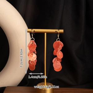 Detail view of long orange shell tassel earrings showing 7.2cm length and size measurements