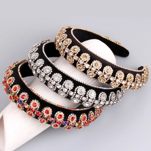 Baroque style velvet headbands set with colorful rhinestones on a display stand