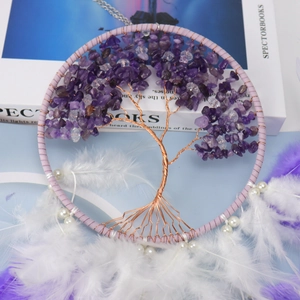 Detailed view of Tree of Life dream catcher with amethyst stones and soft feathers