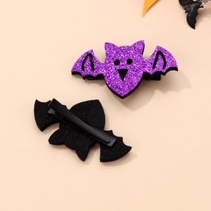 Detail of Halloween bat hair clips showing purple glitter front and black metal clip back