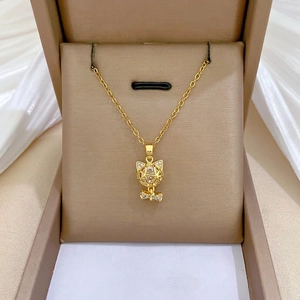 Elegant gold titanium necklace featuring a crystal cat pendant with diamond bow accents