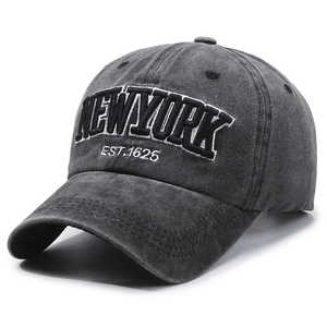 Washed charcoal grey baseball cap with New York embroidery in a 45-degree side view