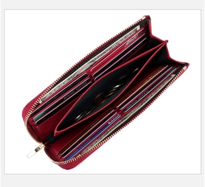 Macro view of the red leather wallet interior with multiple card slots and zipper pocket