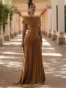 Elegant off-the-shoulder pleated evening gown in golden yellow with slim fit silhouette