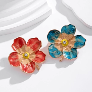 Gradient enamel plum blossom brooches in red and blue with rhinestones and gold trim