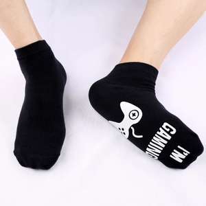 Black cotton game socks with white I'M GAMING text and controller grip on sole